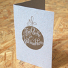 Fröhliche Weihnachten. Recycling-Weihnachtskarten mit goldener Weihnachtsbaumkugel
