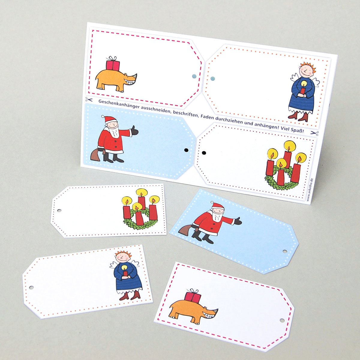 Nashorn, Engel mit Kerze, Weihnachtsmann und Adventskranz, vier gelochte Recycling-Geschenkanhänger zum Ausschneiden: Postkarte