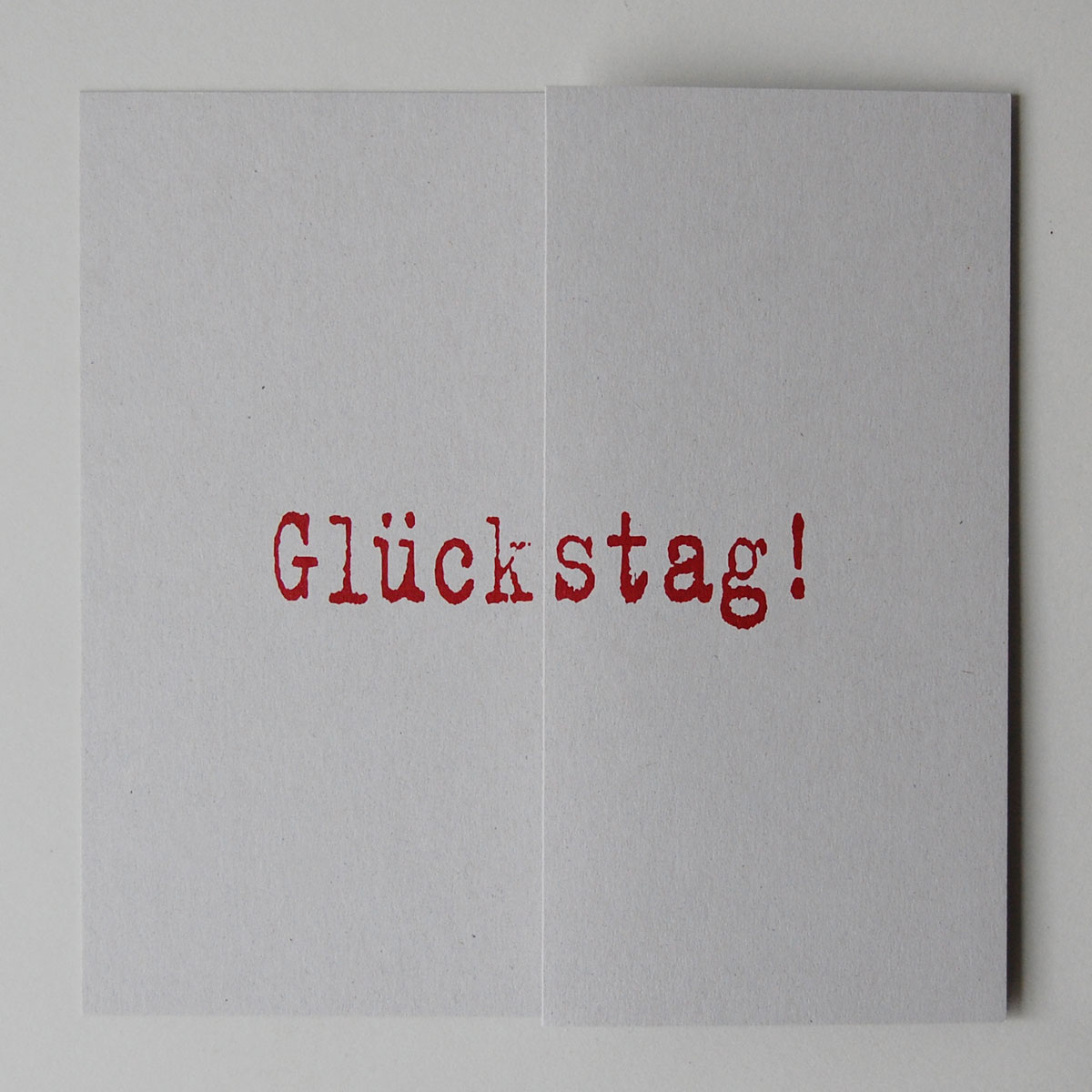 Design-Glückwunschkarte mit dem gedruckten Text: Glückstag!