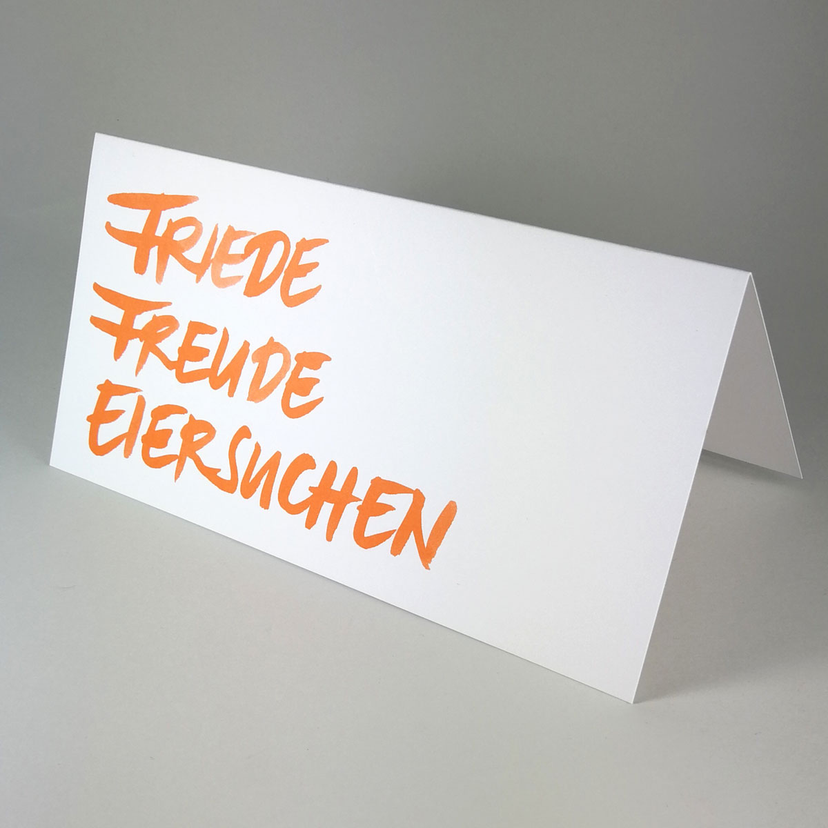 Friede Freude Eiersuchen, Osterkarten mit schwungvoller Handschrift in orange