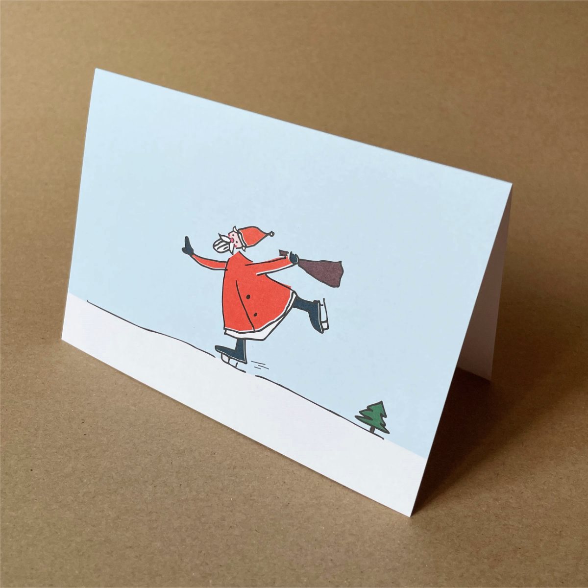 witzige Weihnachtskarten: schlittschuhlaufender Weihnachtsmann